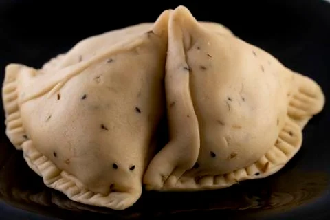 Samosa on black plate Stock Photos