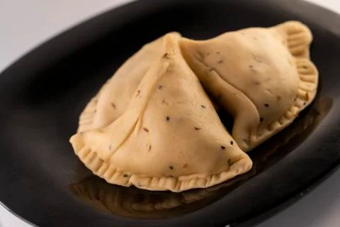 Samosa on black plate Stock Photos