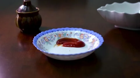Samosa is dipped in ketchup by two Indian hands Stock Footage 138753032