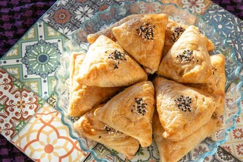 Samosa made from puff pastry. A triangular pie with meat filling with sesam.. Stock Photos