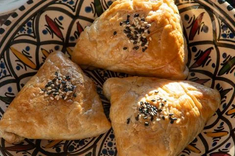 Samosa made from puff pastry. A triangular pie with meat filling, sprinkled.. Stock Photos
