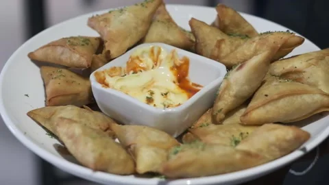 Samosas on a bowl Stock Footage 237472192