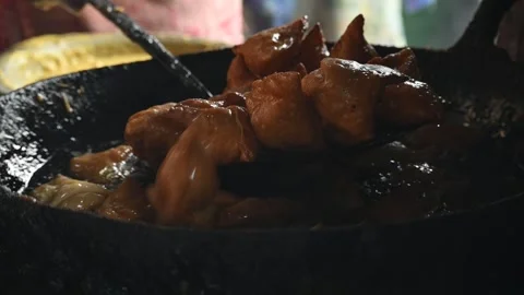 Samosas deep frying in a large iron wok. 動画素材 347036489