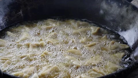 Samosas sizzling Stock Footage 344810975