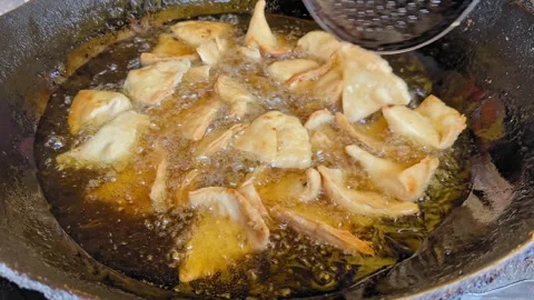 Samosas Stirred While Deep Frying Stock Footage 325153892