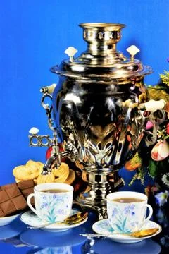 Samovar-tea drinking from cups, sweet food cookies and chocolate. Stock Photos