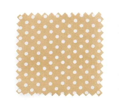 Sample of beige fabric with polka dot pattern isolated on white, top view Foto stock