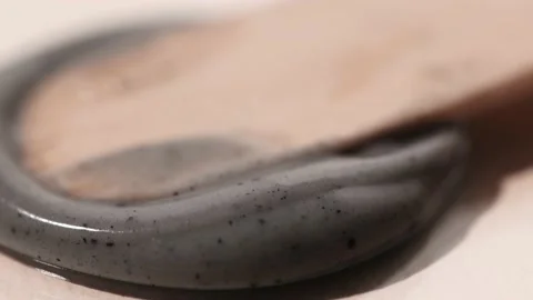 Sample of a charcoal mask on a beige background close-up. Stock Footage 232371417