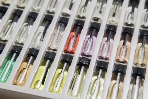 Sample of colored perfume bottles with different types of fragrances and arom Stock Photos