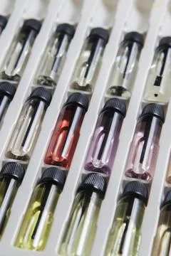 Sample of colored perfume bottles with different types of fragrances and arom Stock Photos