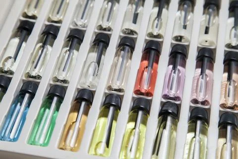 Sample of colored perfume bottles with different types of fragrances and arom Foto stock