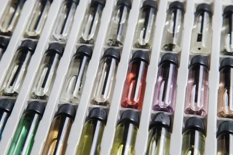 Sample of colored perfume bottles with different types of fragrances and arom Stock Photos