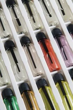 Sample of colored perfume bottles with different types of fragrances and arom Stock Photos