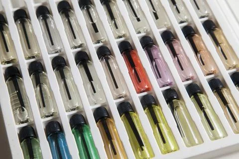 Sample of colored perfume bottles with different types of fragrances and arom Stock Photos