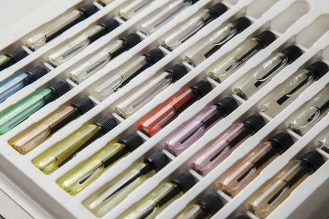 Sample of colored perfume bottles with different types of fragrances and arom Stock Photos