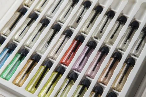 Sample of colored perfume bottles with different types of fragrances and arom Stock Photos