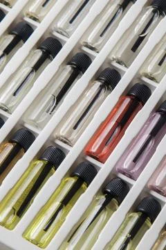 Sample of colored perfume bottles with different types of fragrances and arom Stock Photos