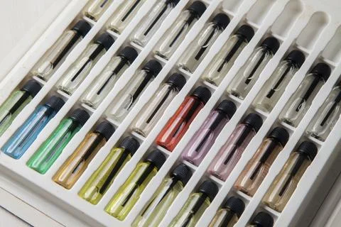 Sample of colored perfume bottles with different types of fragrances and arom Stock Photos