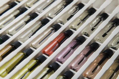 Sample of colored perfume bottles with different types of fragrances and arom Stock Photos