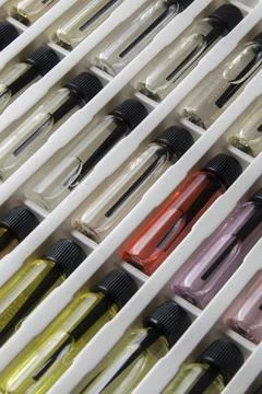 Sample of colored perfume bottles with different types of fragrances and arom Stock Photos