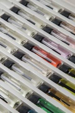 Sample of colored perfume bottles with different types of fragrances and arom Stock Photos