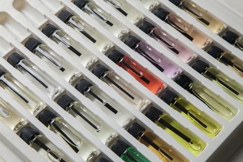 Sample of colored perfume bottles with different types of fragrances and arom Stock Photos