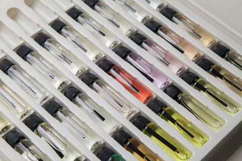 Sample of colored perfume bottles with different types of fragrances and arom Stock Photos