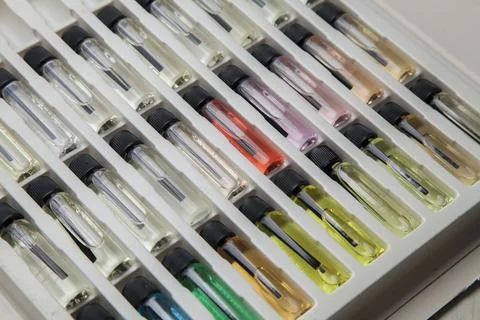 Sample of colored perfume bottles with different types of fragrances and arom Stock Photos