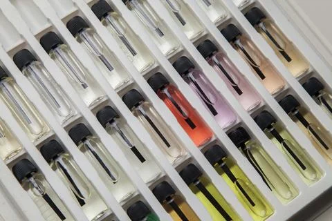 Sample of colored perfume bottles with different types of fragrances and arom Stock Photos