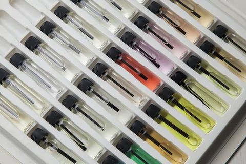 Sample of colored perfume bottles with different types of fragrances and arom Stock Photos