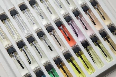 Sample of colored perfume bottles with different types of fragrances and arom Stock Photos