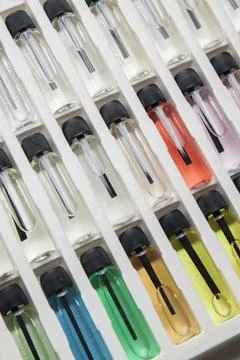 Sample of colored perfume bottles with different types of fragrances and arom Stock Photos