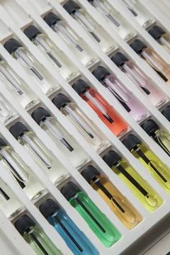 Sample of colored perfume bottles with different types of fragrances and arom Stock Photos