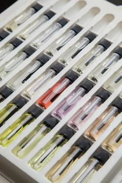 Sample of colored perfume bottles with different types of fragrances and arom Stock Photos