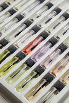 Sample of colored perfume bottles with different types of fragrances and arom Stock Photos