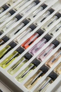 Sample of colored perfume bottles with different types of fragrances and arom Stock Photos