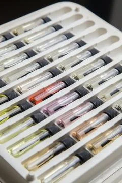 Sample of colored perfume bottles with different types of fragrances and arom Stock Photos