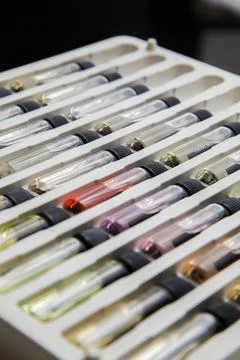 Sample of colored perfume bottles with different types of fragrances and arom Stock Photos