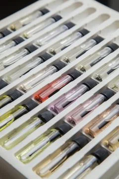 Sample of colored perfume bottles with different types of fragrances and arom Stock Photos