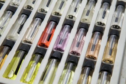 Sample of colored perfume bottles with different types of fragrances and arom Stock Photos