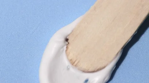 A sample of a cosmetic cream being smeared with a wooden spatula Video stock 231768194