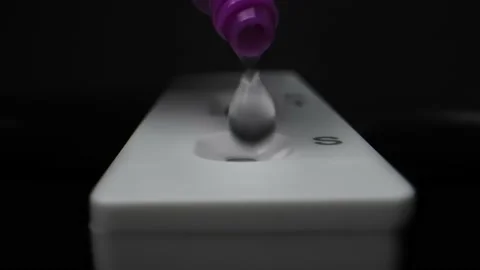 Sample drop for home rapid antigen test for COVID-19, extreme close-up Video stock 172146525