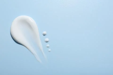 Sample of face cream on light blue background, top view. Space for text Stock Photos