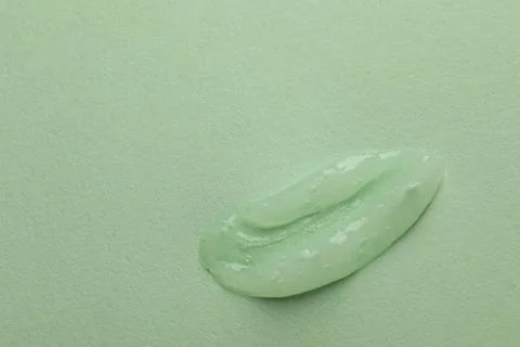 Sample of face gel on light green background, top view. Space for text Stock Photos