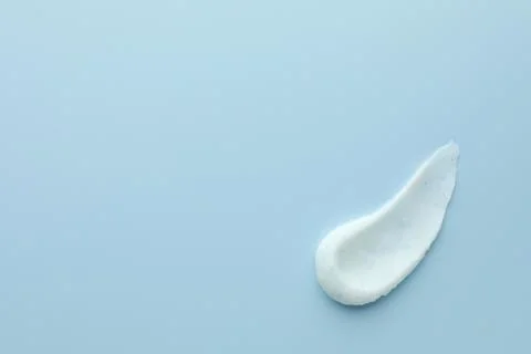 Sample of face scrub on light blue background, top view. Space for text Stock Photos