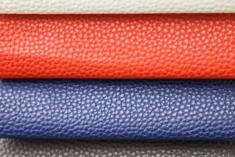 Sample - a good quality leather in various colors. Blue, red, white pieces of Stock Photos