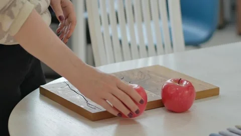 A sample of laminated chipboard or natural veneer is on the table. A woman decor Stock Footage 255232539
