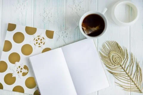 Sample layout of New Year's greetings with snowflakes, open notebook, cup of Stock Photos