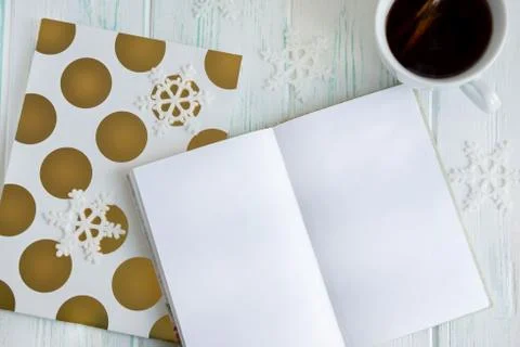 Sample layout of New Year's greetings with snowflakes, open notebook, cup of Stock Photos