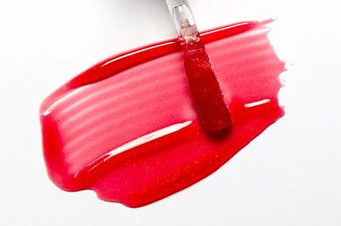 A sample of lip moisturizer on a white background. Oil or lip balm. Stock Photos